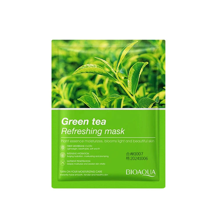 Green tea refreshing mask packaging with green tea leaves on a white background