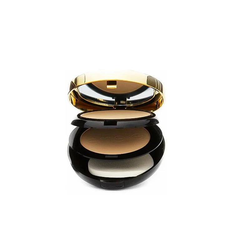 Compact powder in a black case with a gold lid on a white background
