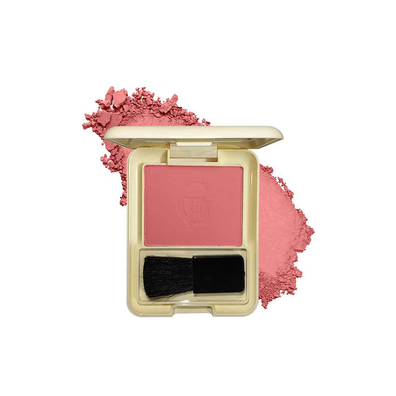 Compact blush with a brush and scattered powder on a white background