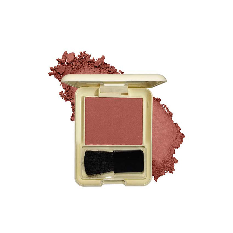 Compact blush with a brush and scattered powder on a white background