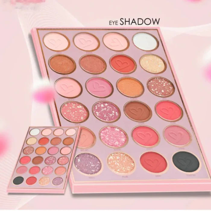 Makeup eye shadow palette with various colors on a pink background